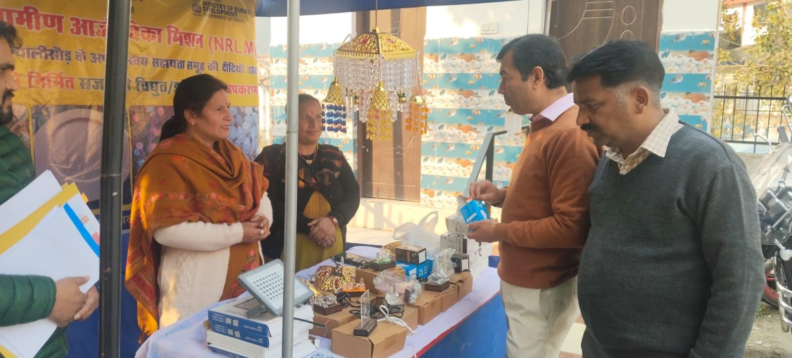 Women of an SHG showing LED decorative lamps they manufacture at a National Rural Livelihood Mission stall
