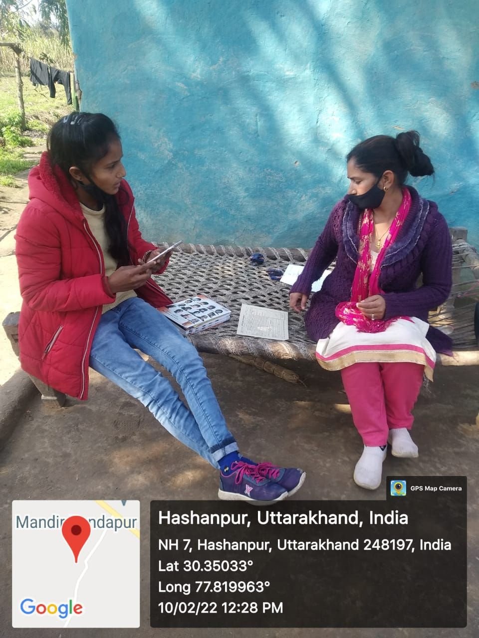 An IIEWS field surveyor recording household details during a survey