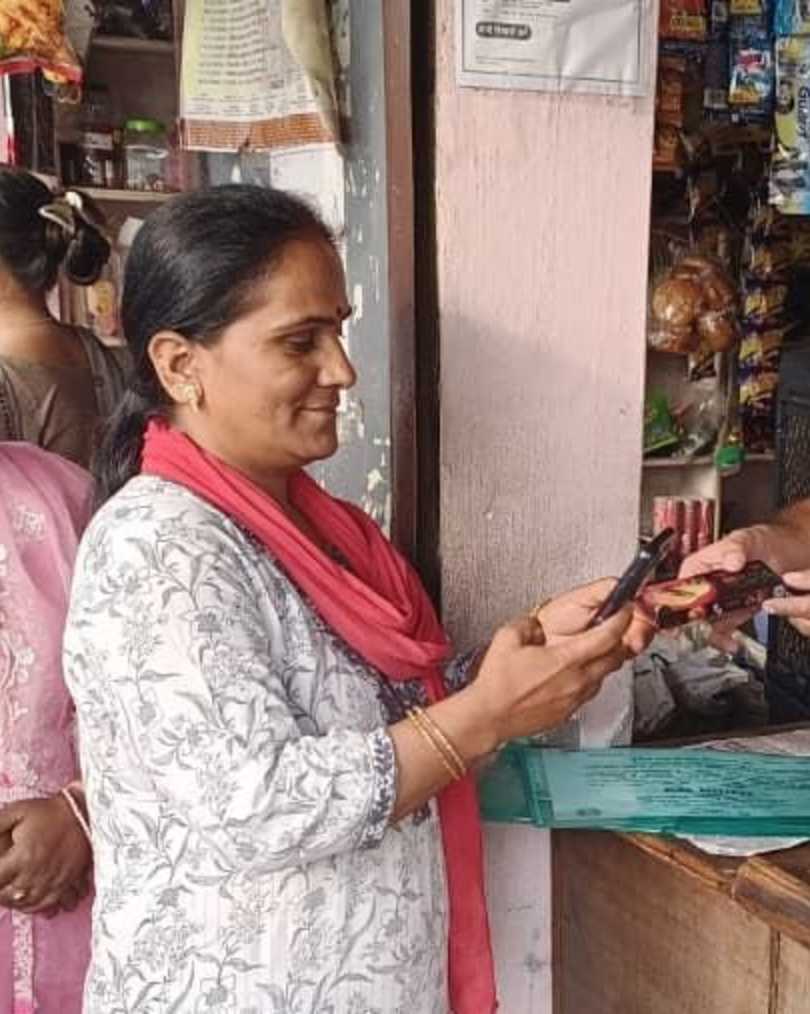 Women trained under the digital literacy mission practising an online payment at a shop counter in Vikasnagar, Uttarakhand
