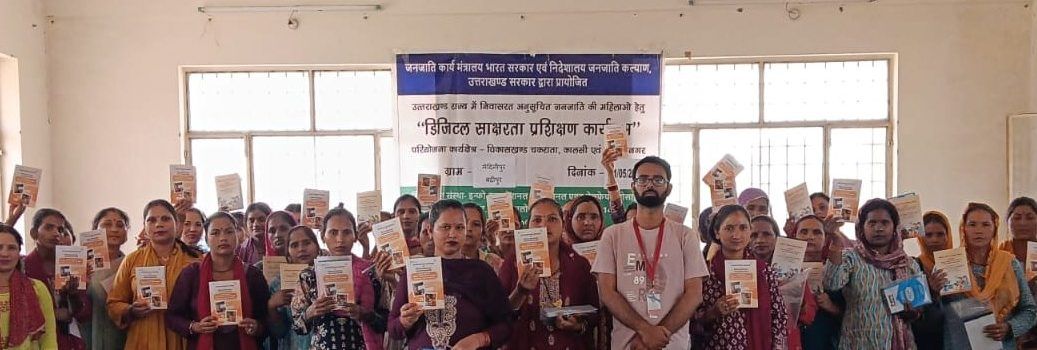 Women holding their handbooks at a digital literacy training programme in Uttarakhand